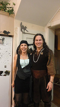 smiling couple in pirate costumes
